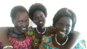 Akur, Anna, and Abuk working at the PESS office