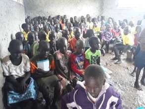 Students  in a classroom affected by water and mud