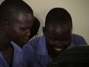 Girls reading Menstrual Cycle Chart