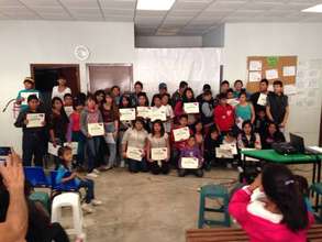Graduates with their diploma.