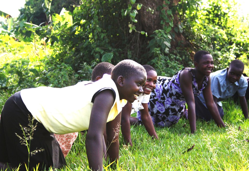 Teen Girls soak up some rays during a yoga class.