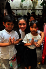 Ms. T with two young students at New Year Party