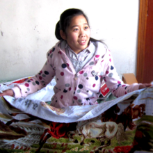 Dan Dan showing her cross-stitch