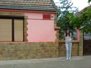 Aleksandra in front of her new house