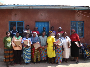 Participants proudly hold their solar cookers