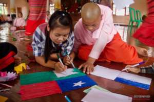 Girls create a decorative Pa'O flag