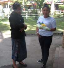 Mayra gives Juana a graduation gift.