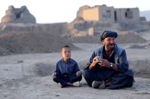 Afghan boy and man with radio: Barat Ali Batoor