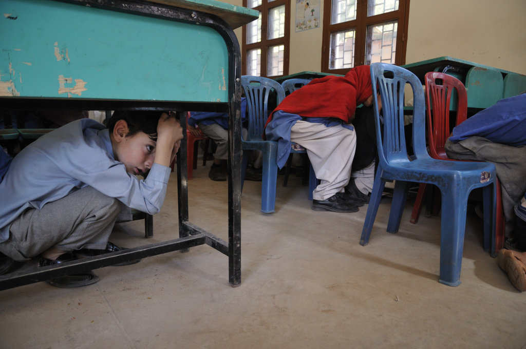 Adeel practices taking shelter under his desk.