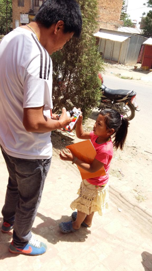 A child receiving medicine and a "story book"