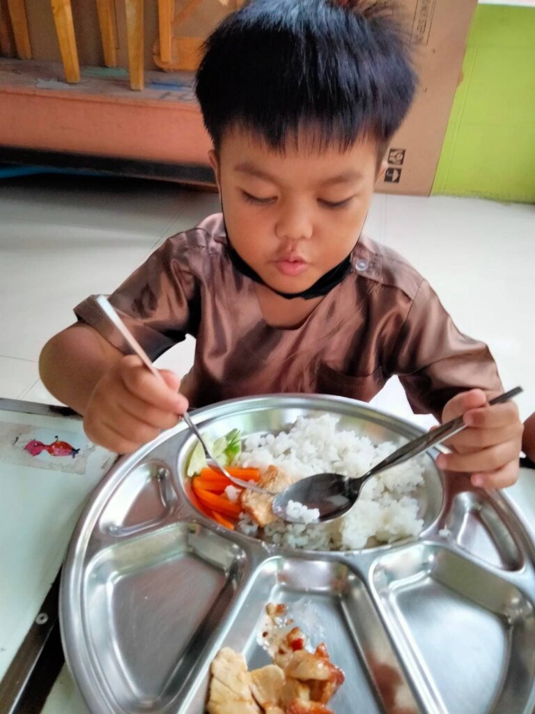Rice for malnourished slum kindergartners