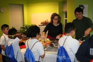 Children receive a hot meal at the holiday party.