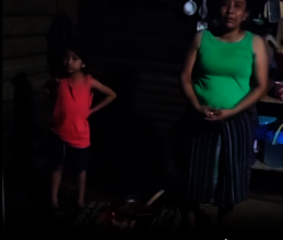 Petrona and her daughter cooking over an open fire