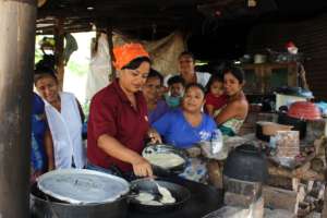 HRI staff member, Xiomara, giving a cooking lesson