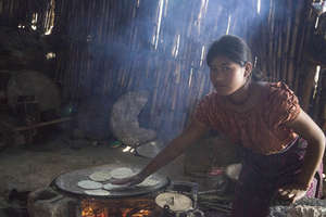 Woman cooking with traditional fire method