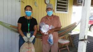 Participant receiving groceries & hygiene kits