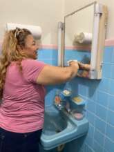 Housekeeper cleaning restroom