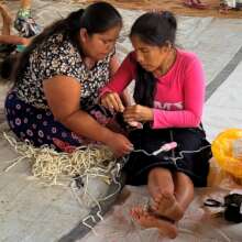 Artisan apprentice facilitator helping participant