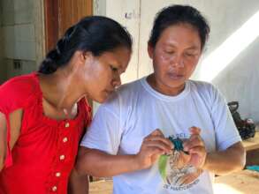 Doilith showing Bora artisan to weave a butterfly