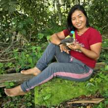 Artisan Marianela posing with woven bird