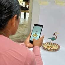 Artisan photographing craft in studio conditions