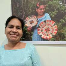 Artisan Doris with photo of her at exhibition