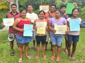 Graduates show certificates & appreciation posters