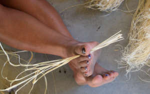 Artisan feet holding chambira palm fiber