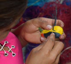 Artisan weaving wire-tailed manakin bird ornament