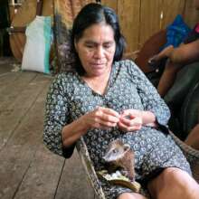 Artisan Doris feeding her orphaned coati