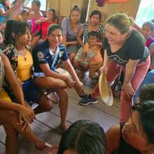 Anna explaining Days for Girls kit to young woman