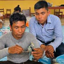 Wenceslao shows Reninger how to make a blue heron