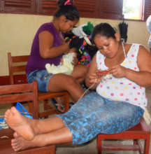 One artisan weaving; one artisan nursing