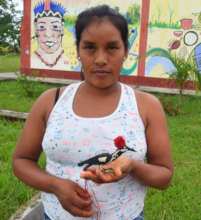 Bora artisan Kori with woodpecker ornament