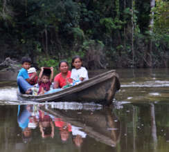 8. Family in peque-peque en route to village