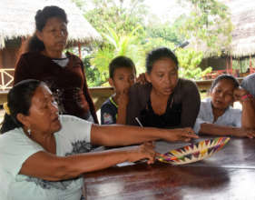 Artisans describe multi-colored basket for catalog