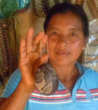 Murui artisan with wildlife carved ornament