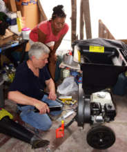 Chris adjusting shredder with CACE coordinator