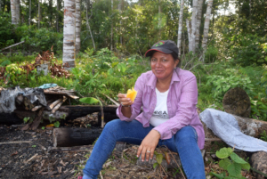 Yully enjoying fresh pinneapple in a partner field