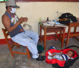 Artisan dad with baby at workshop in Puca Urquillo