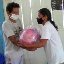 Delivering food relief package to Bora villager