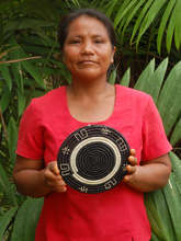 Artisan with woven chambira hot pad. Plowden/CACE