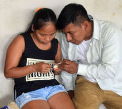 Edson teaching woman artisan at workshop