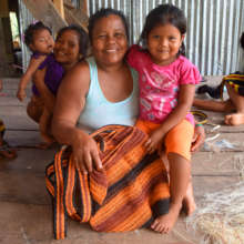 Bora artisan with woven bag and daughter /CACE