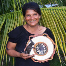 Francisca with woven chambira basket and ornament