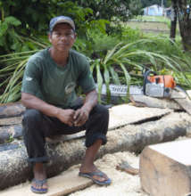 Bora man with chainsaw and wooden planks
