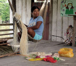 Bora artisan in hammock with chambira fiber