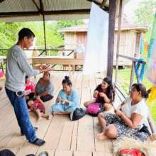 Facilitator explaining craft quality to artisans