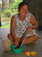 Artisan grating fruit pod dye. Plowden/CACE