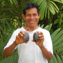 Lucio with carved calabash rattle ornaments